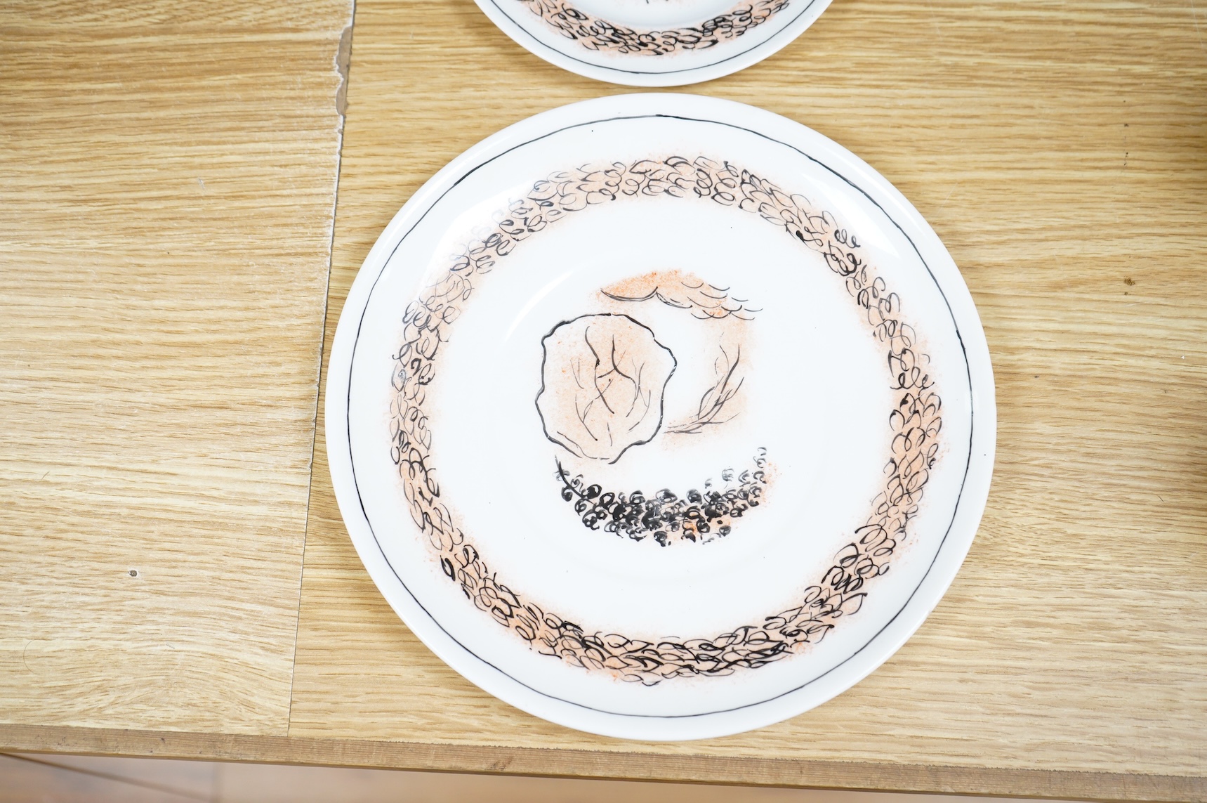 Laura Knight for Foley China cupid plate and matching side plate, together with a Graham Sutherland for Foley China plate and matching side plate, largest 23cm in diameter